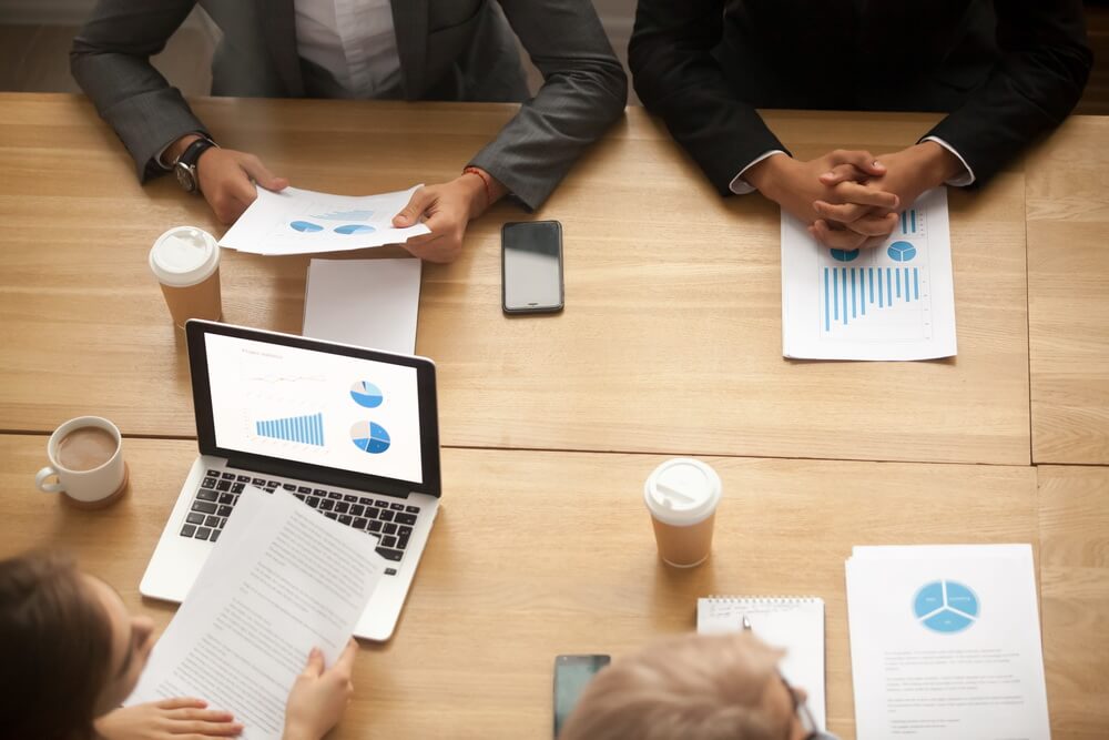 A business owner reviewing annual report and statement of information filing deadlines across several states to keep each entity in good standing