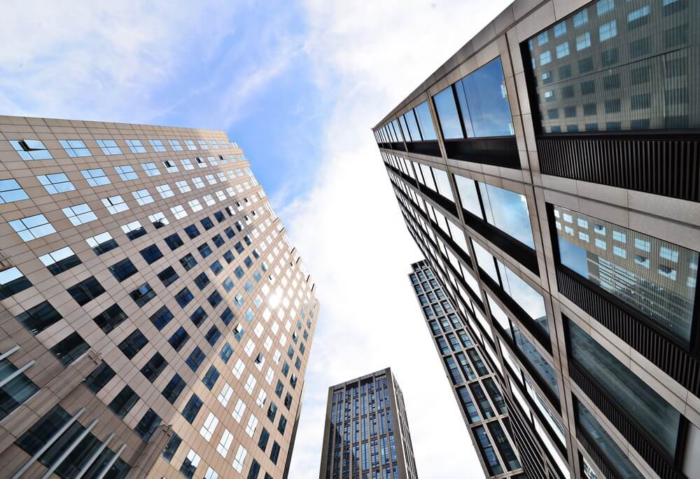 A commercial building with a lender's force-placed insurance notice — coverage bought on the owner's behalf at a higher premium after a policy lapse