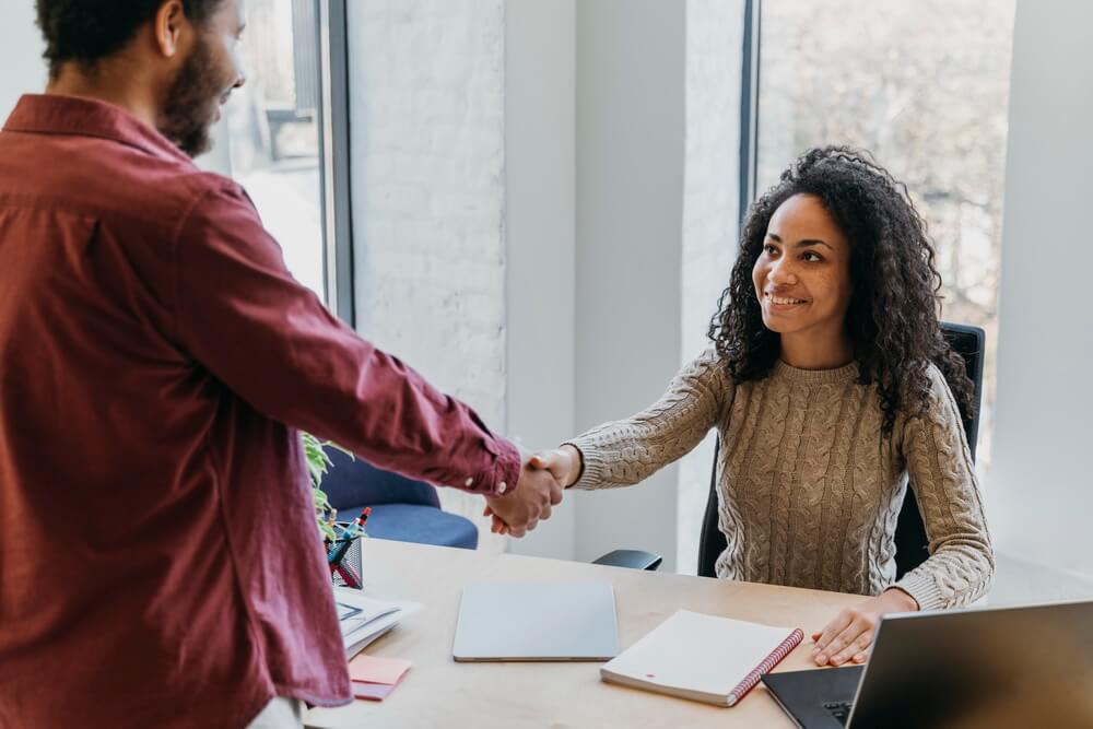An HR team reviewing signed employment agreements and the milestone dates buried inside them — probation ends, fixed-term ends, and surviving non-compete periods
