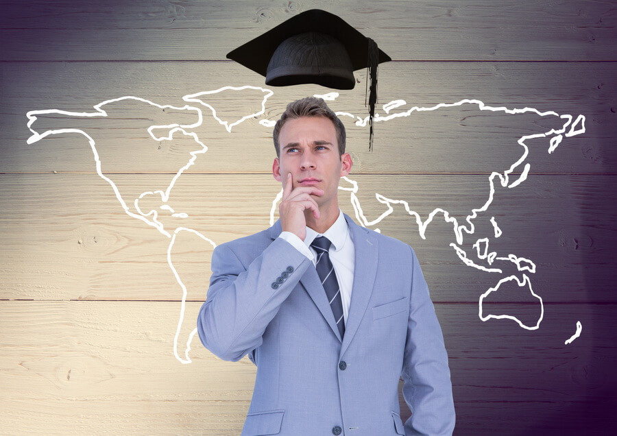 A businessman pausing to consider where his company is authorized to do business, standing before a map outline drawn on a wooden wall