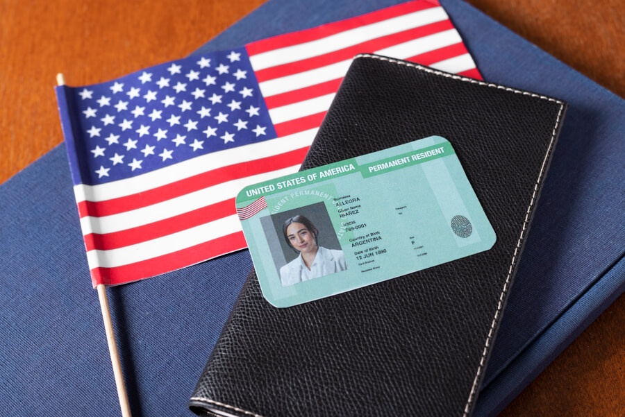 A permanent resident checking the expiration date printed on a Permanent Resident Card (Form I-551) against the Form I-90 renewal filing window
