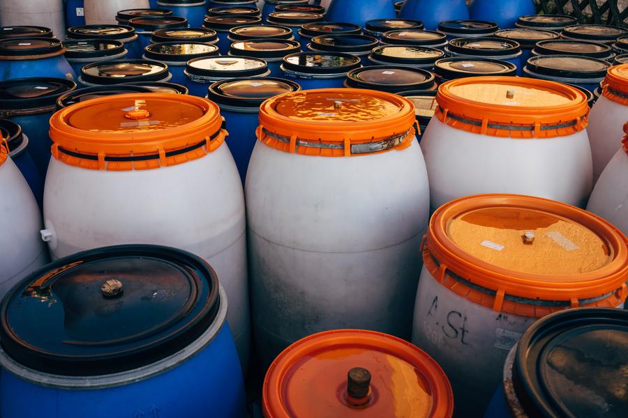 Environmental team reviewing RCRA hazardous waste generator status categories VSQG SQG LQG and re-notification and biennial report dates across sites