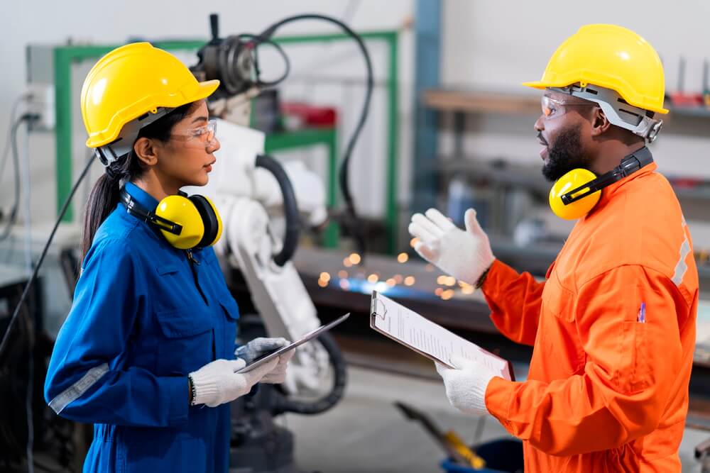 A maintenance technician applying a lockout padlock and tag to an electrical disconnect on a de-energized machine — controlling hazardous energy before servicing