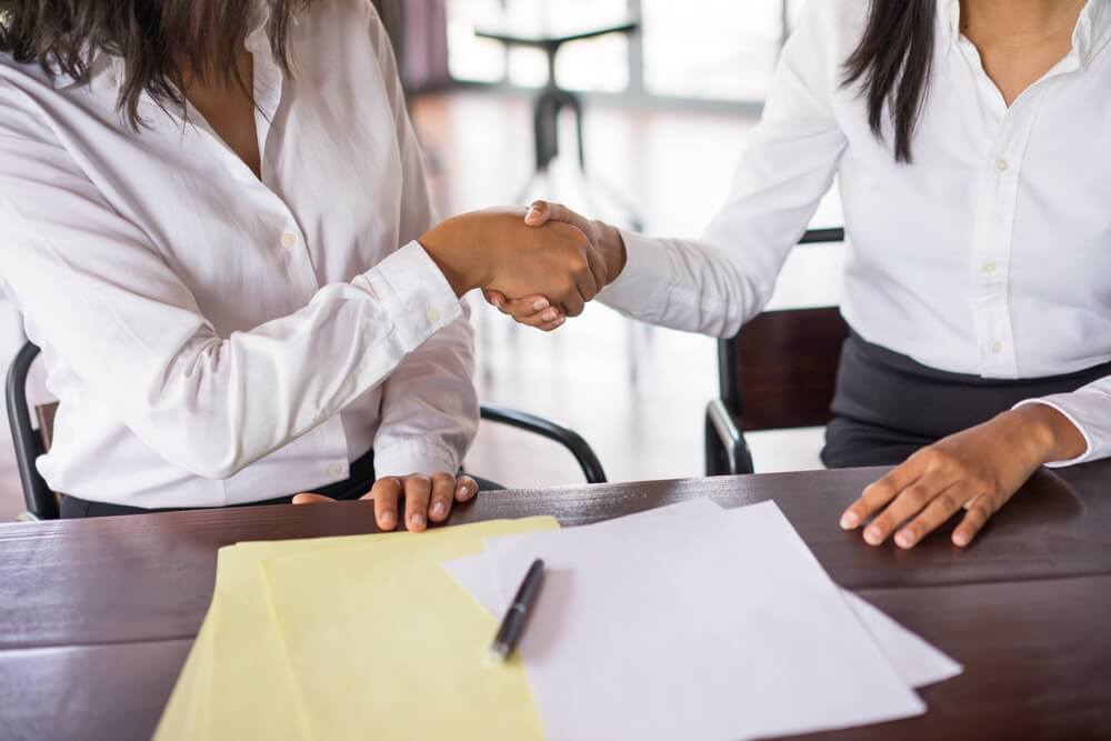 Two business teams reviewing a signed master service agreement and its statements of work before an auto-renewal notice deadline