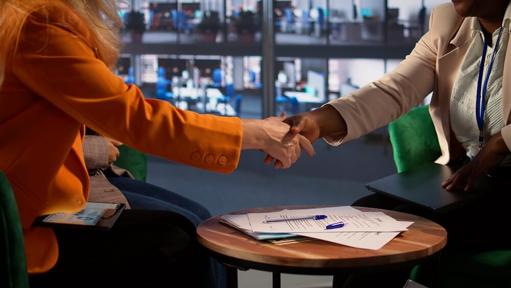 Business partners reviewing the capital contribution deadlines, buyout windows, and notice periods written into their partnership agreement