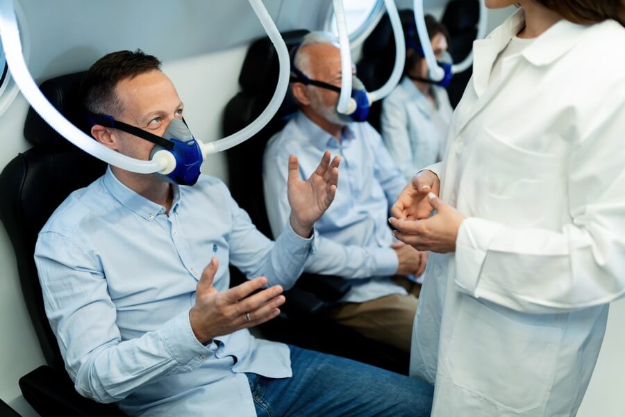 A worker wearing a tight-fitting respirator during a fit test — the annual test is valid only for that specific respirator and only while the wearer's medical clearance is current