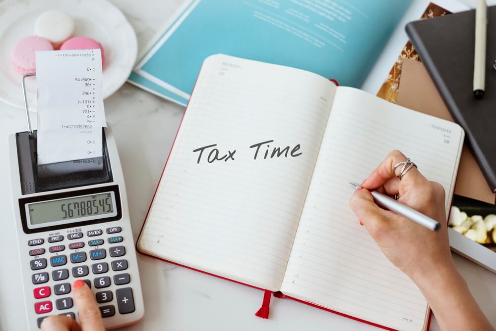 A finance manager reviewing sales tax permits and each state's filing frequency and return due dates on a calendar