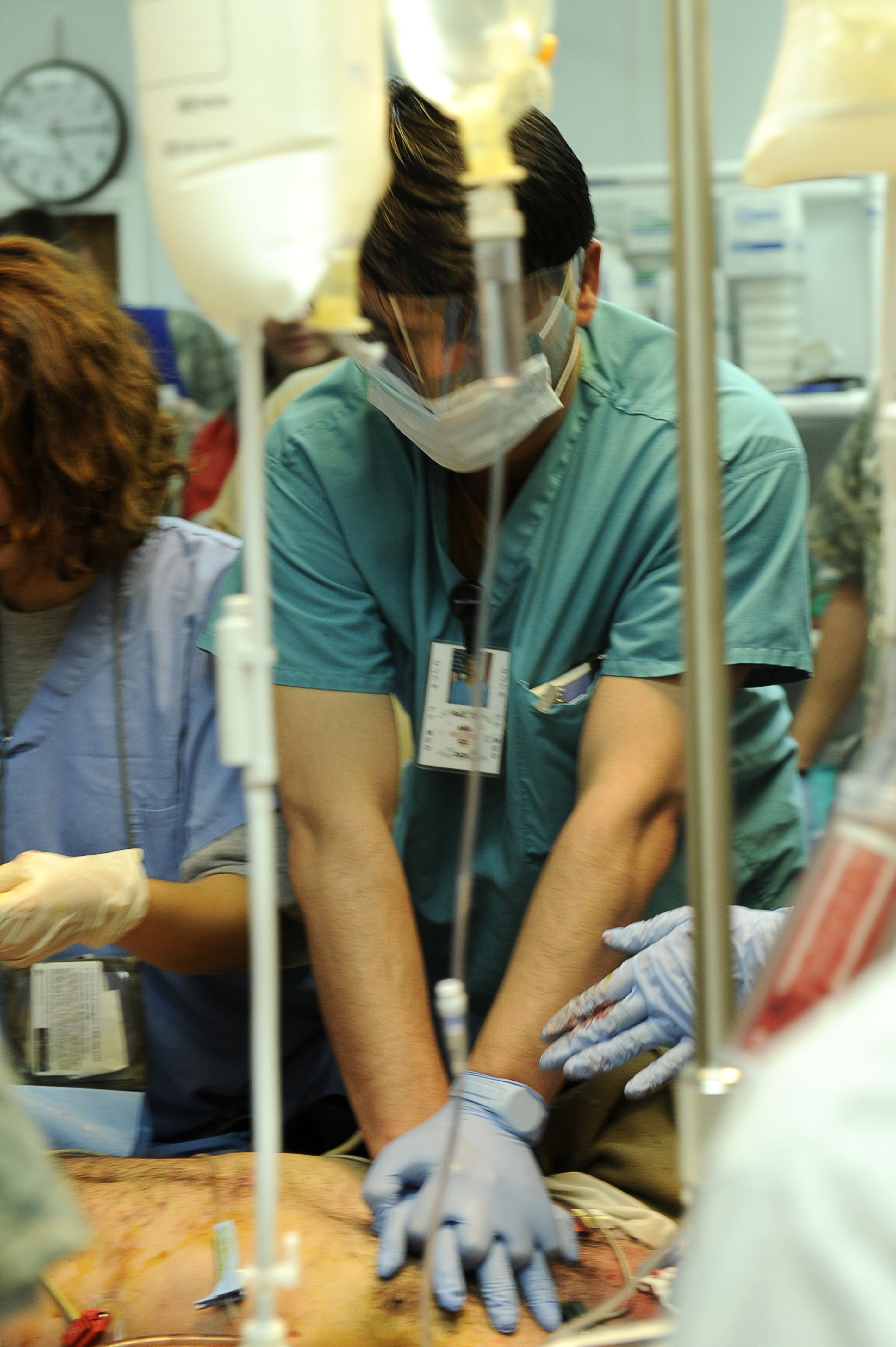 Healthcare professional responding to cardiac emergency, ACLS training and patient care.