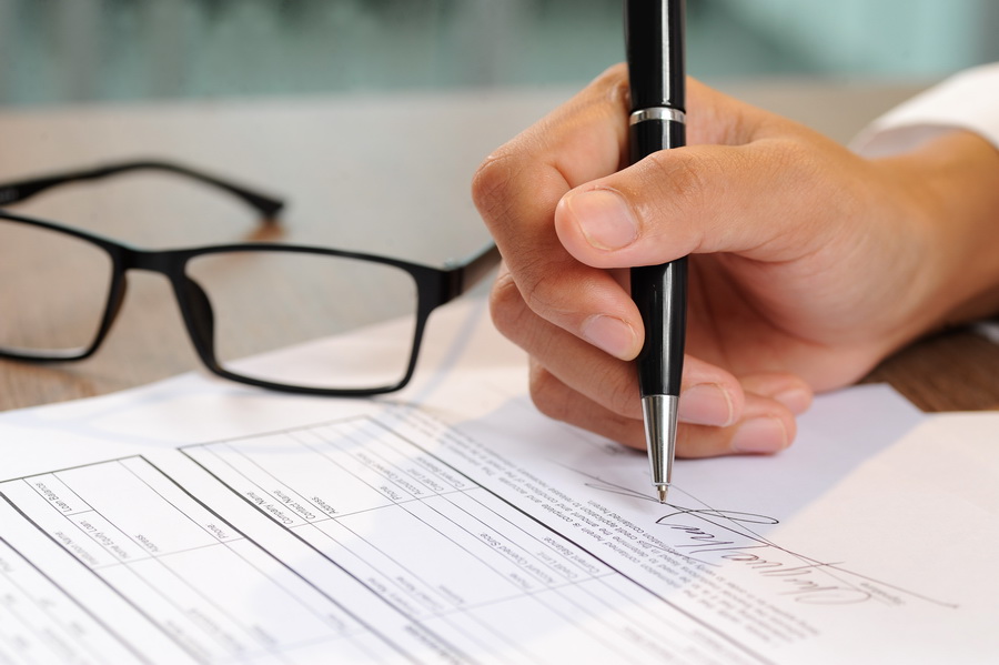 Trade license renewal paperwork being signed